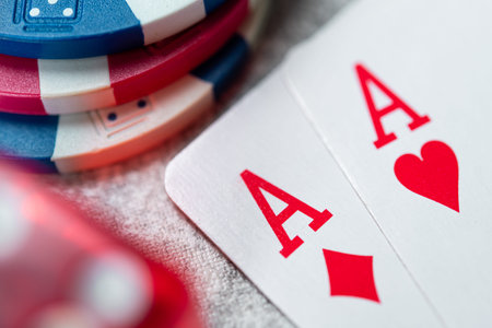 Successful first hand in poker game, pair of aces on a casino table background.