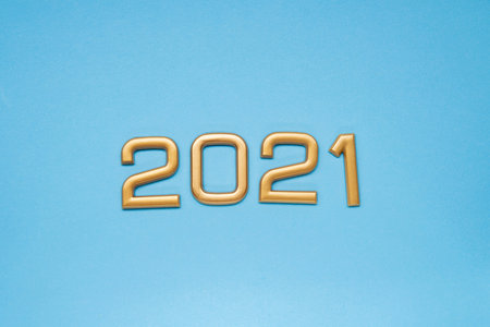 Happy New Year 2021 golden numbers on a blue background. Top view.