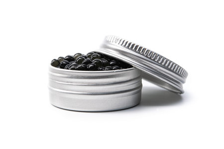 Black caviar in metal container isolated on white background