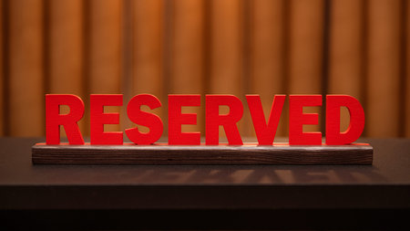 Service reserve at restaurant table. Large red plaque with wooden letters.の写真素材
