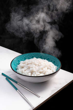 Hot rice pho noodles on white table on black background. asian food.の写真素材