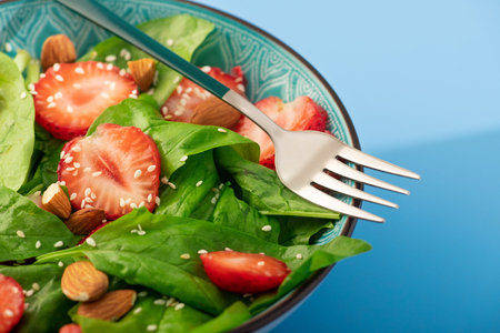 Diet food dish. Strawberry salad with spinach and almonds. healthy and vegan food background.の写真素材