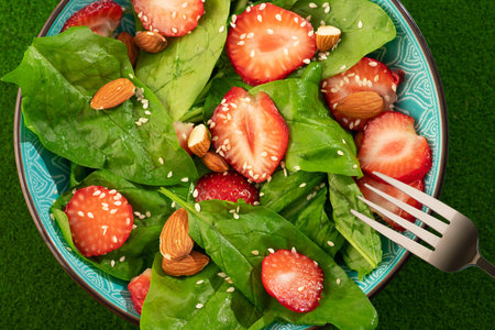 Diet food dish. Strawberry salad with spinach and almonds. healthy and vegan food background. top view.の写真素材