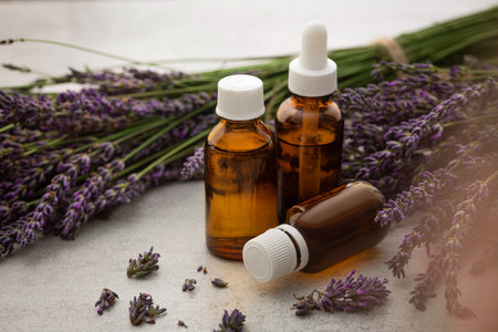 Production of perfumes from lavender. Cosmetologist's office. Oil and flowers on a stone table background.の写真素材