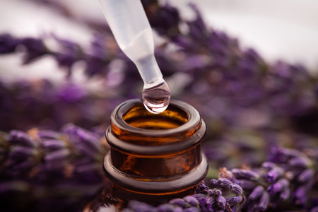 Closeup of lavander oil and liquid bottle in flowers on background. Skin care, aromatherapy spa.の写真素材
