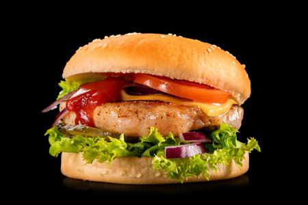 Fresh tasty fillet burger isolated on a black background. fast food concept.の写真素材