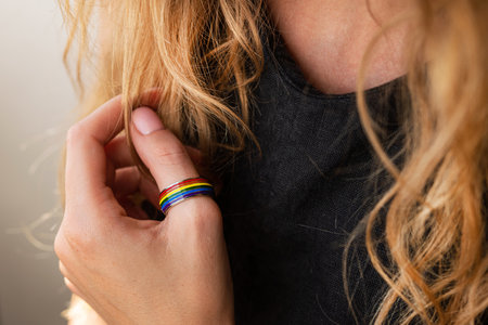 Blonde woman with a wedding lgbt ring on a finger.の写真素材