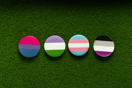 Bisexual, genderqueer, transgender, asexual badges on a green lawn grass. top view. Freedom and tolerance concept.の写真素材