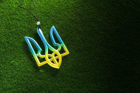 Trident Ukraine emblem on a green grass background. War.Peace. symbol. top view.の写真素材