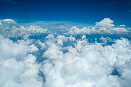 Cumulus white clouds floating on a blue sky