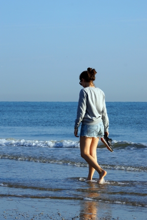 RIMINI-AVGUST 31, the girl walks at morning o'clock on the coast of the Mediterranean Sea. 31.08.2013. Italy, Europeのeditorial素材