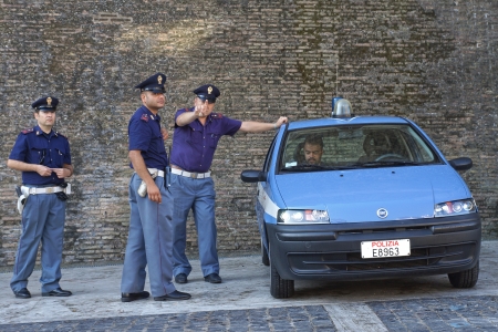 ROME-ITALY, AUGUST 28, Italian police on duty at the walls of the Vatican in Rome August 28, 2013  Servant of the law expresses dissatisfaction with the photo sessionのeditorial素材