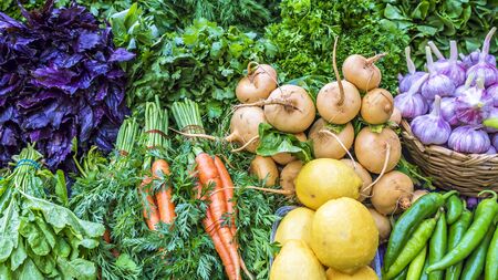 fresh vegetables and herbs on the counter marketの写真素材