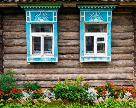 facade of the old wooden houses decorated with flowers