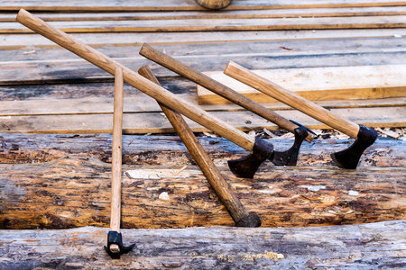 carpenter tools-axes on a background of lumber
