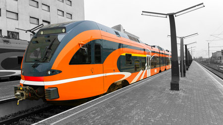Orange high-speed train on the platform of the train stationのeditorial素材