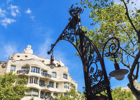 BARCELONA, SPAIN - SEPTEMBER 15: A beautiful street light on the background of the world-famous home of the Casa Mila, or La Pedrera September 15, 2015.のeditorial素材