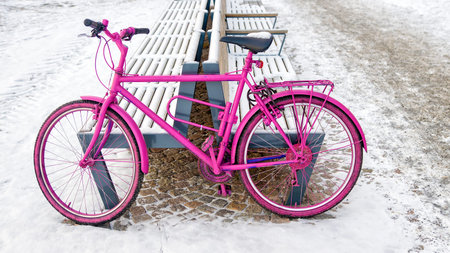 pink bike on a snowy streetの写真素材