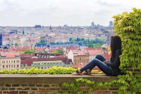 Girl on the background of the panorama of Prague, Czech Republicのeditorial素材