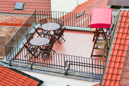 balcony with furniture on a tiled roofの写真素材
