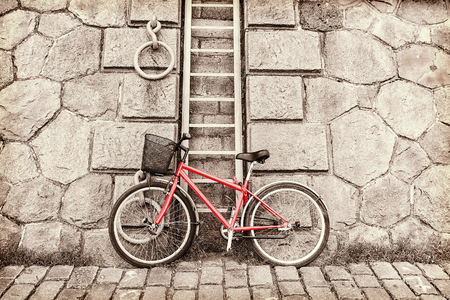 red bicycle on a background of a stone wallの写真素材