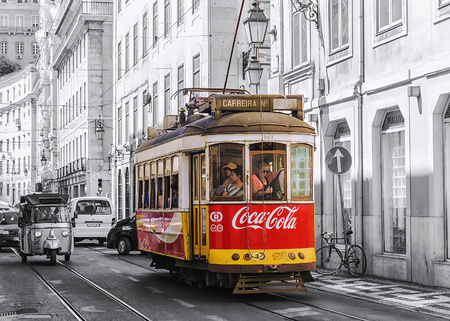LISBON, PORTUGAL, SEPTEMBER 9, 2015: historic red retro tram advertising company Coca-Cola, the move to Lisbon Street LISBON, PORTUGAL, SEPTEMBER 9, 2015: historic red retro tram advertising company Coca-Cola, the move to Lisbon Street