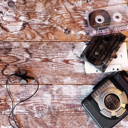old cassette player and audio tape on a wooden backgroundの写真素材