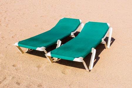 Two deck chairs on the beach