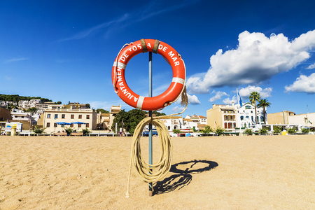 lifebuoy on the beach in Tossa de Mar, Spain. an inscription on a circle in Catalan: Tossa de Marの写真素材