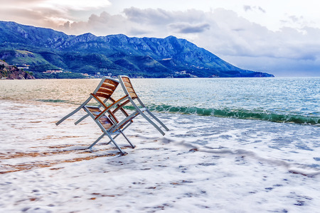 Two chairs in the sea wave.の写真素材