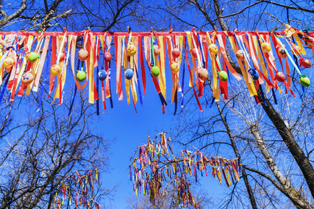 Festive decoration of trees with colorful ribbonsの写真素材