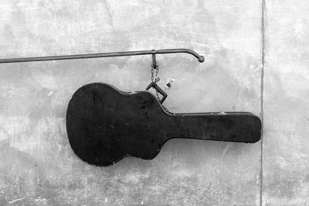 Guitar case on the background of a concrete wallの写真素材