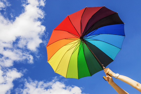 Multi-colored umbrella on the sky backgroundの写真素材