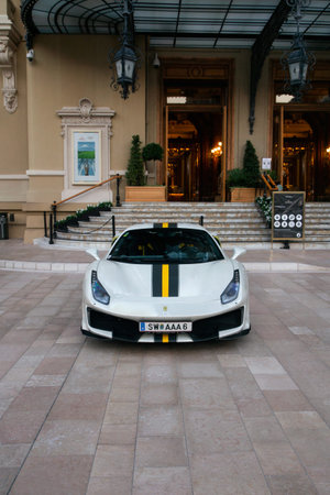 Monaco-Ville, Monaco - August 2021: white with yellow and black stripe Ferrari 488 Pista supercar...