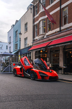 London, United Kingdom - September 2021: orange McLaren Senna modern supercar parked at a restaurant in central London with open doors.のeditorial素材