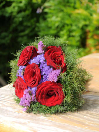 small bouquet of red roses on the tableの写真素材