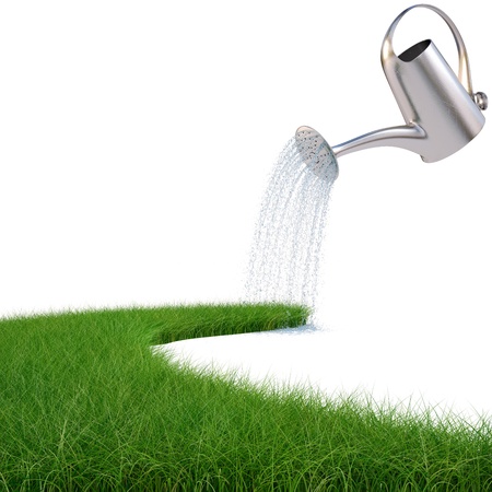 watering can pouring water on the road from the grass. isolated on white.の写真素材