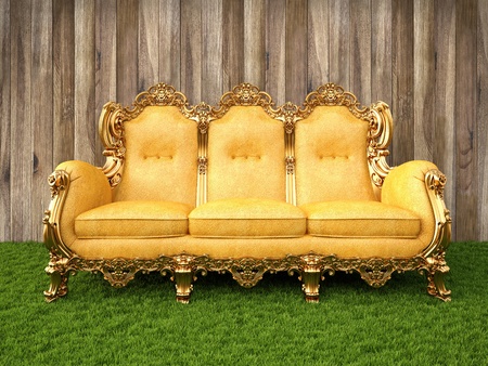 gold sofa in a room with a floor of grass.の写真素材