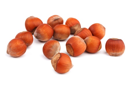 A few ripe hazelnuts on a white backgroundの写真素材