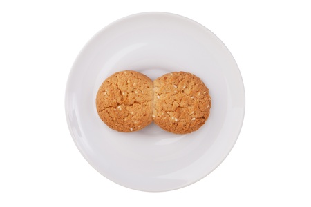Two fused-glass cookies on a white saucer on a white backgroundの写真素材