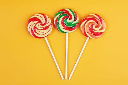 Three striped lollipop on an orange background