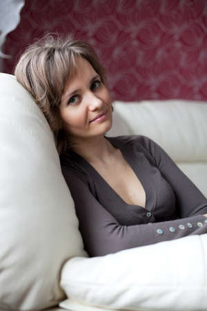 Young woman has settled comfortably in a chairの写真素材