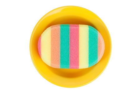 Sponge for washing dishes in a ceramic dish on white backgroundの写真素材