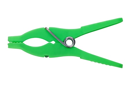 Green plastic clothespins with metal spring on a white backgroundの写真素材