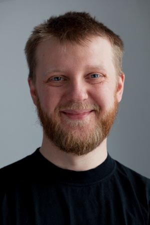 Young upbeat guy with a beard in  black T-shirtの写真素材