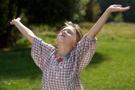 Happy child with divorced his hands on a summer dayの写真素材