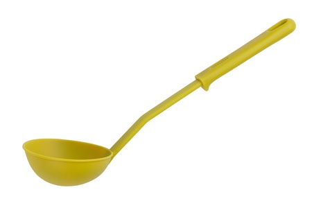The green plastic kitchen spoon on a white backgroundの写真素材