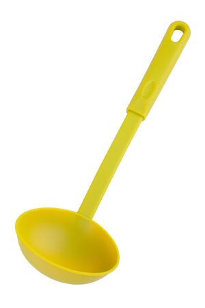 Green plastic kitchen spoon on a white backgroundの写真素材