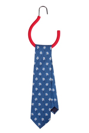 Blue tie hanging on a special hangerの写真素材