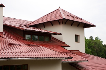 Roof of the house, lined with red roof tilesの写真素材
